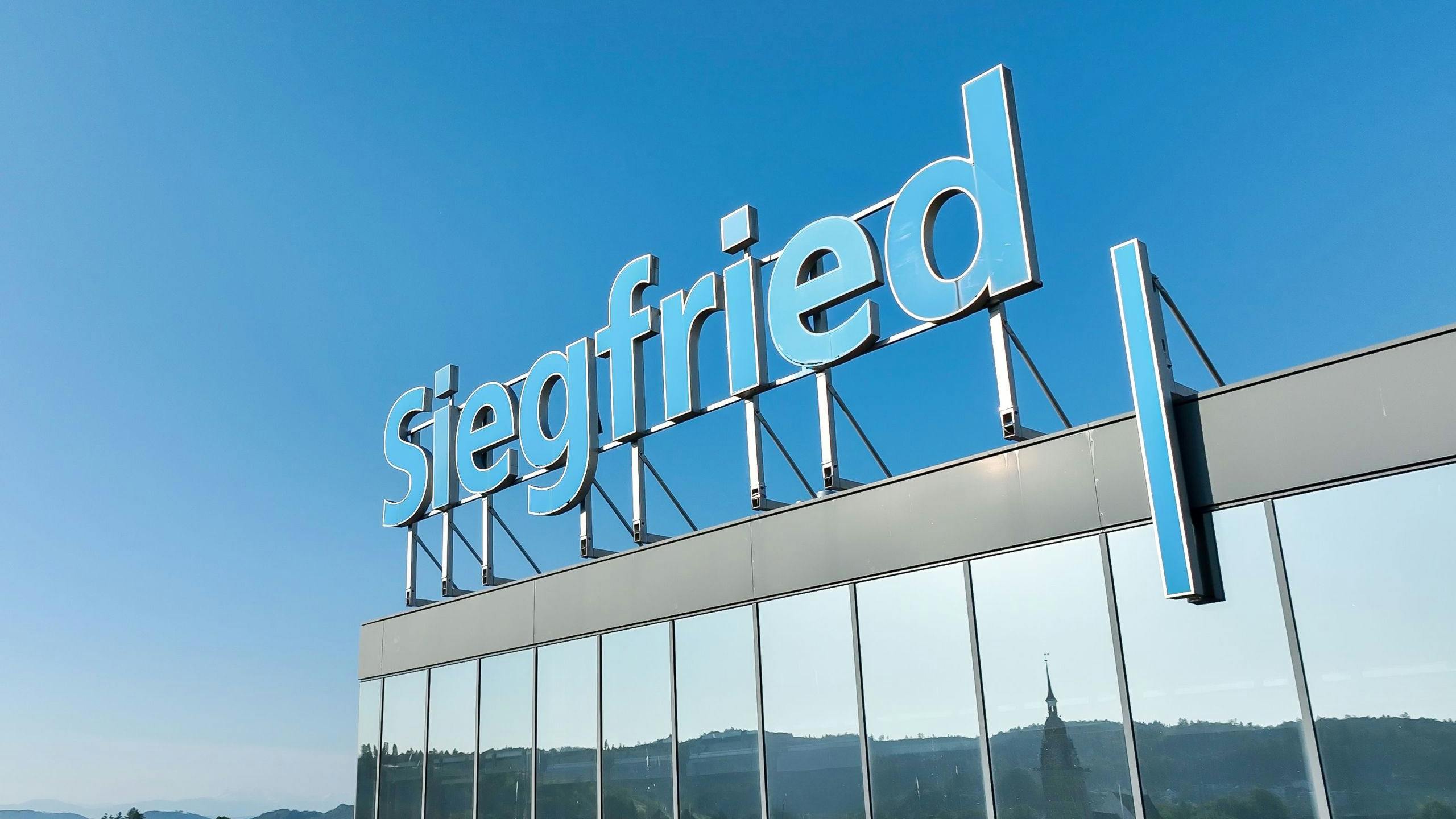 Siegfried sign atop headquarters buiding