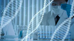 Digital DNA structures sit in foreground and in background a researcher test vials