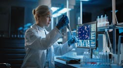 Female scientist working with samples, using micro pipette to analyze in a lab Female scientist working with samples, using micro pipette to analyze in a lab