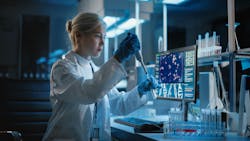 Female scientist working with samples, using micro pipette to analyze in a lab Female scientist working with samples, using micro pipette to analyze in a lab