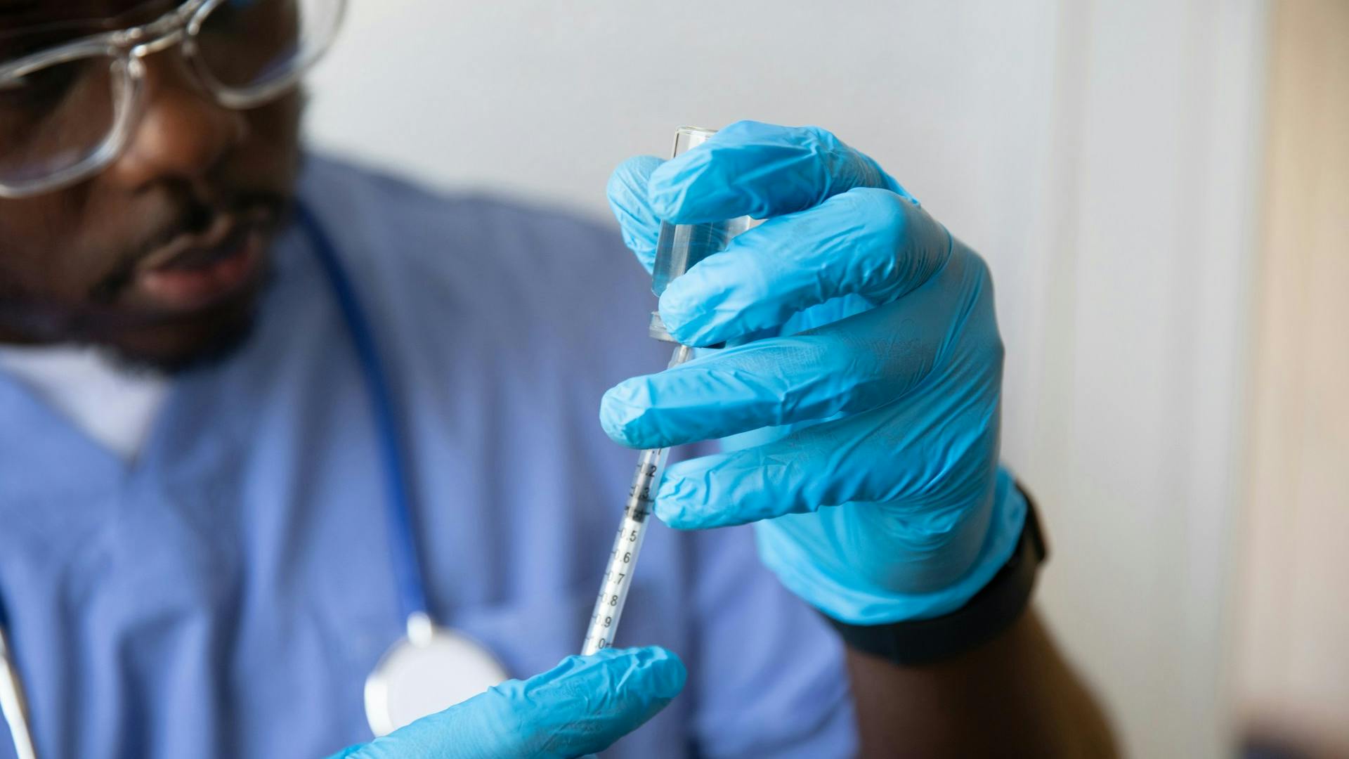Pharma worker administers vaccine