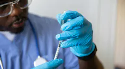 Pharma worker administers vaccine