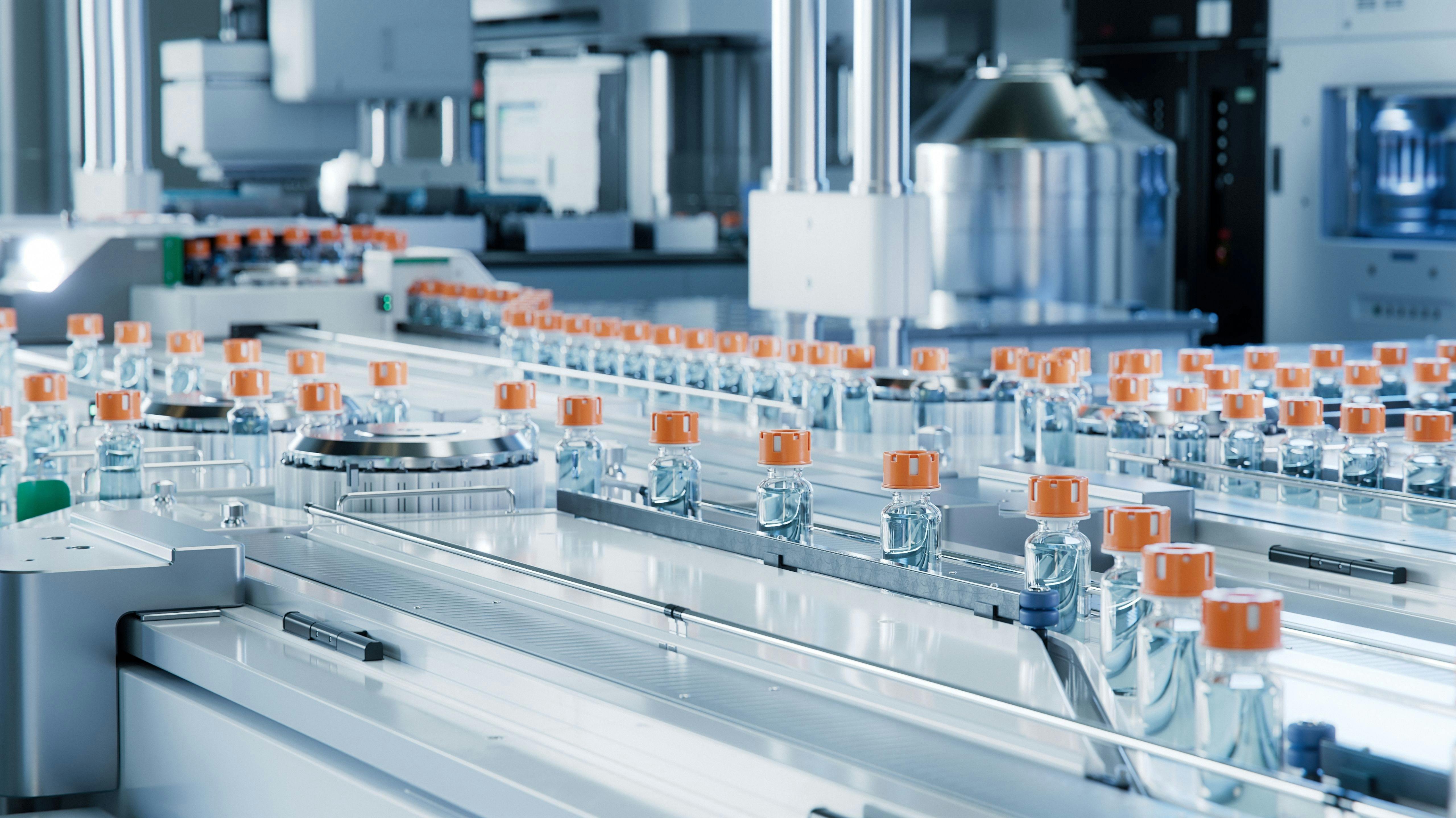 Modern Pharmaceutical Factory. Medical Ampoule Production Line. Rows of Glass Vials with Orange Caps on Conveyor Belt.
