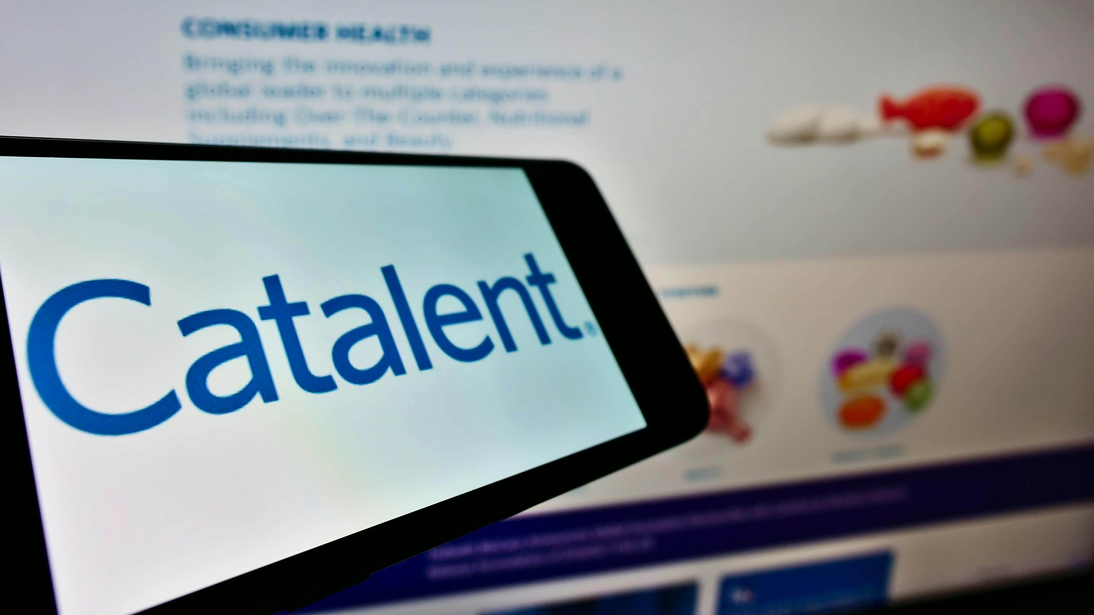 Cellphone with logo of American pharmaceutical company Catalent Inc. on screen in front of business website.