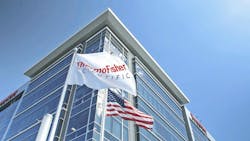 ThermoFisher Scientific flag in front of headquarters building ThermoFisher Scientific flag in front of headquarters building