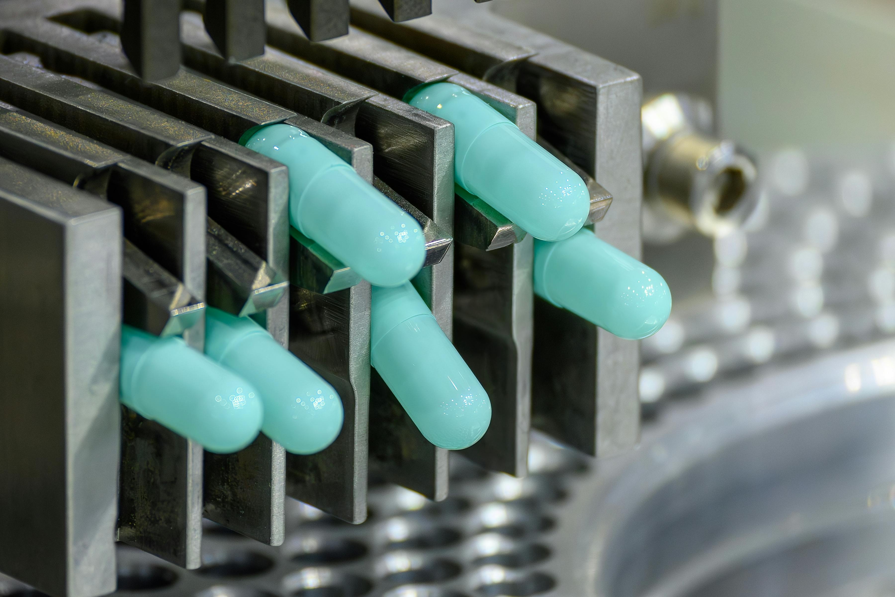 Close-up shot of medicine capsules in tablet manufacturing machine