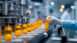 A gloved hand pours pills into a bottle on a conveyor belt in a pharmaceutical manufacturing facility A gloved hand pours pills into a bottle on a conveyor belt in a pharmaceutical manufacturing facility