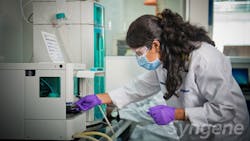 Female Syngene pharma worker in lab coat handles laboratory equipment Female Syngene pharma worker in lab coat handles laboratory equipment
