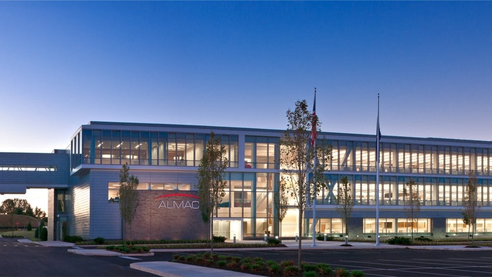 Almac Group exterior building at dusk