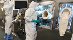 Highly trained specialists on the production line of our radioligand therapy (RLT) manufacturing facility