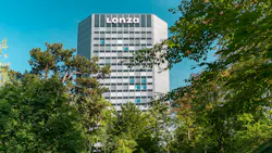 View through the trees of Lonza corporate headquarters building in Switzerland View through the trees of Lonza corporate headquarters building in Switzerland