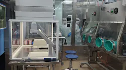 Two pharma workers in PPE at SpectronRx GMP manufacturing site