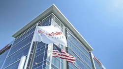 Thermo Fisher Scientific building with the US flag and a flag with ThermoFisher logo Thermo Fisher Scientific building with the US flag and a flag with ThermoFisher logo
