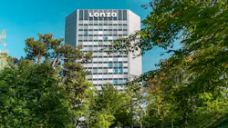 Lonza's corporate headquarters tower in Basel, Switzerland as seen through treeline on bright sunny day Lonza's corporate headquarters tower in Basel, Switzerland as seen through treeline on bright sunny day