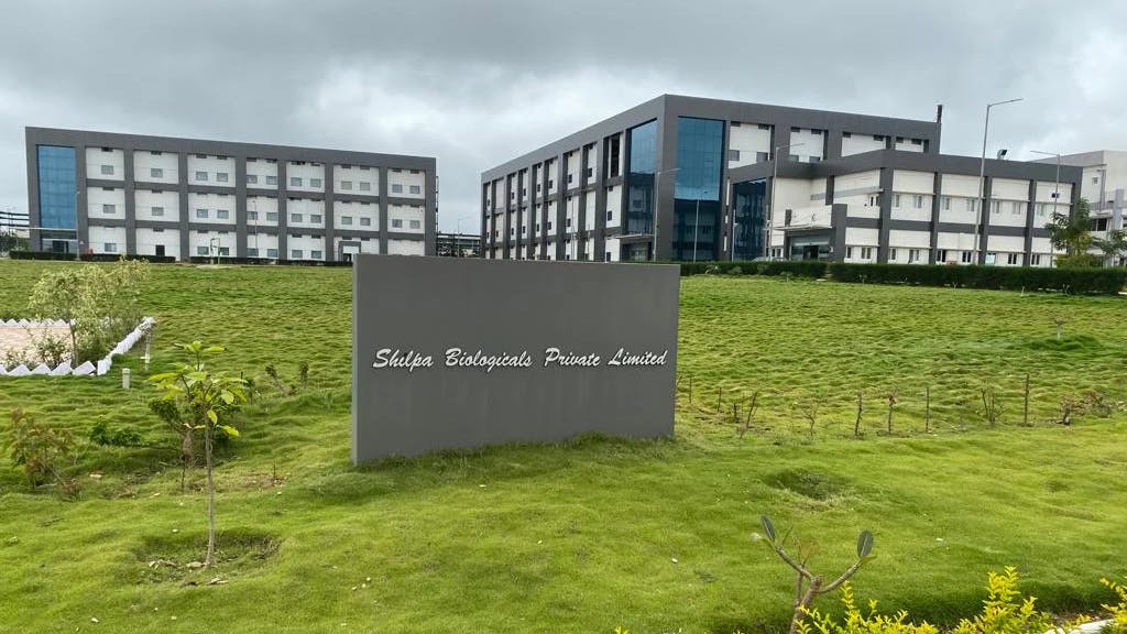 Exterior view of Shilpa Biologics sign with buildings in the background