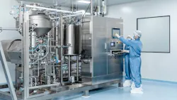 Two workers at control panel of pharma manufacturing equipment at WuXi Biologics facility Two workers at control panel of pharma manufacturing equipment at WuXi Biologics facility