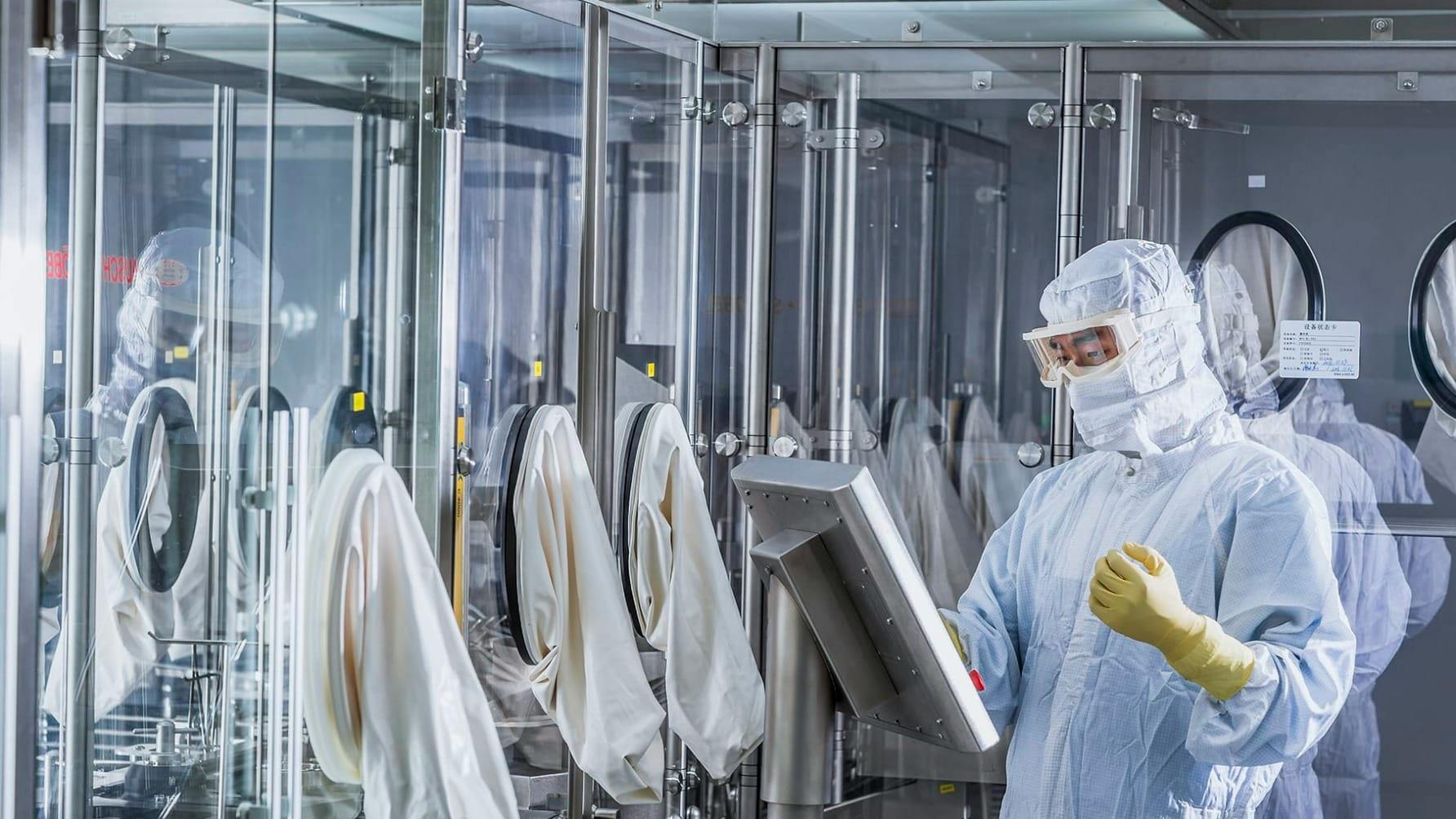 ADC filling line with worker in PPE at Altruist Biologics' China facility