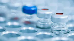 closeup of vials in pharma manufacturing line