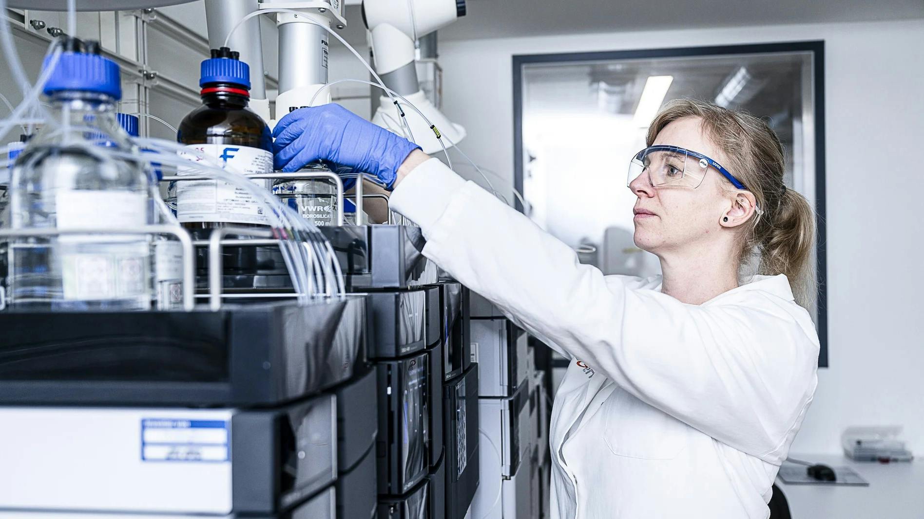ProBioGen scientist in front of pharma equipment