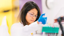 MilliporeSigma employee in white lab coat at St Louis area R&D facility