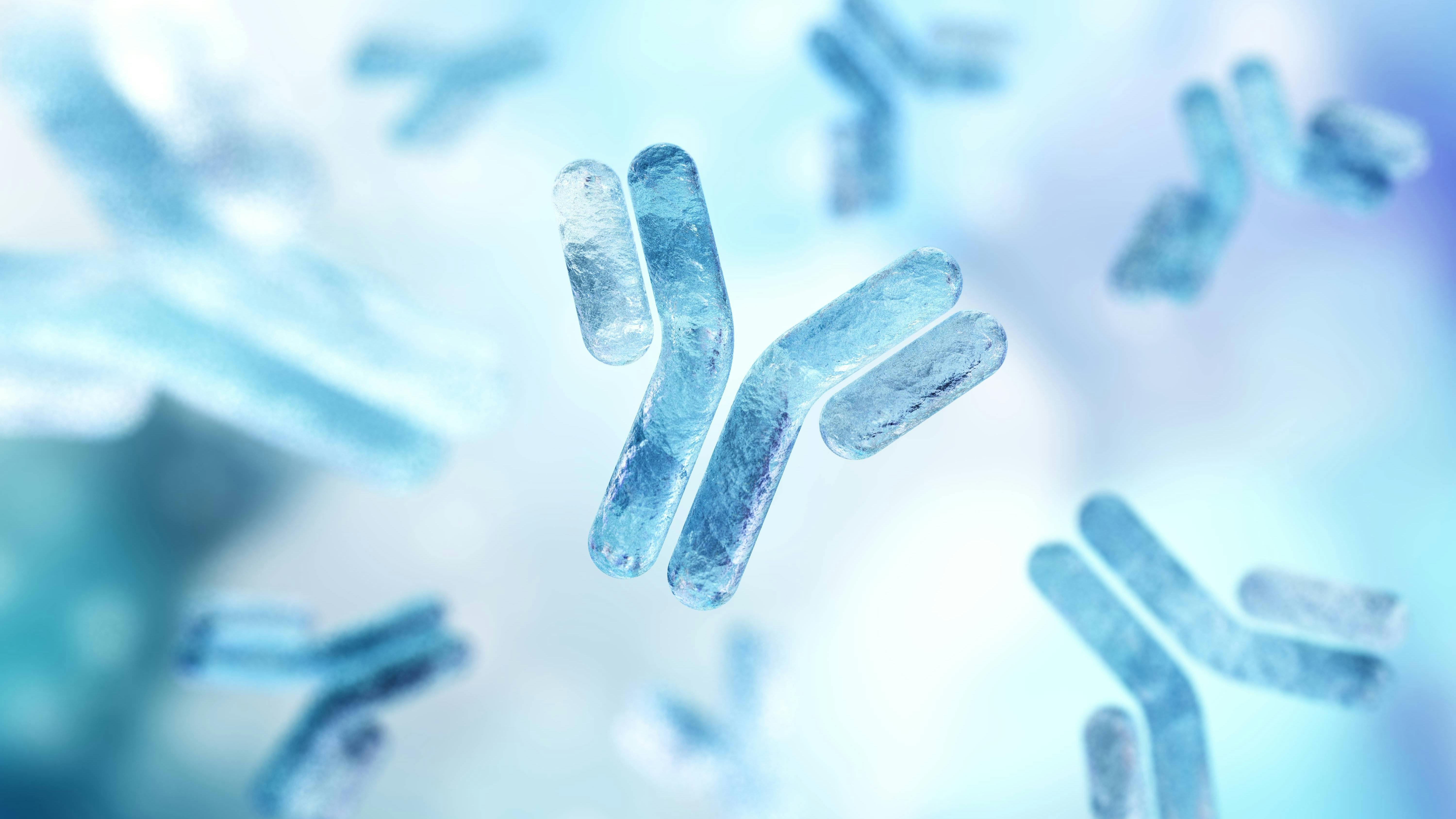 3D illustration of multiple Y-shaped antibody molecules floating on a light blue background.