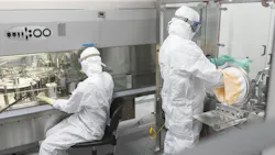 Pharma workers in full PPE at Evonik facility