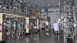 Worker inspects equipment inside pharma facility