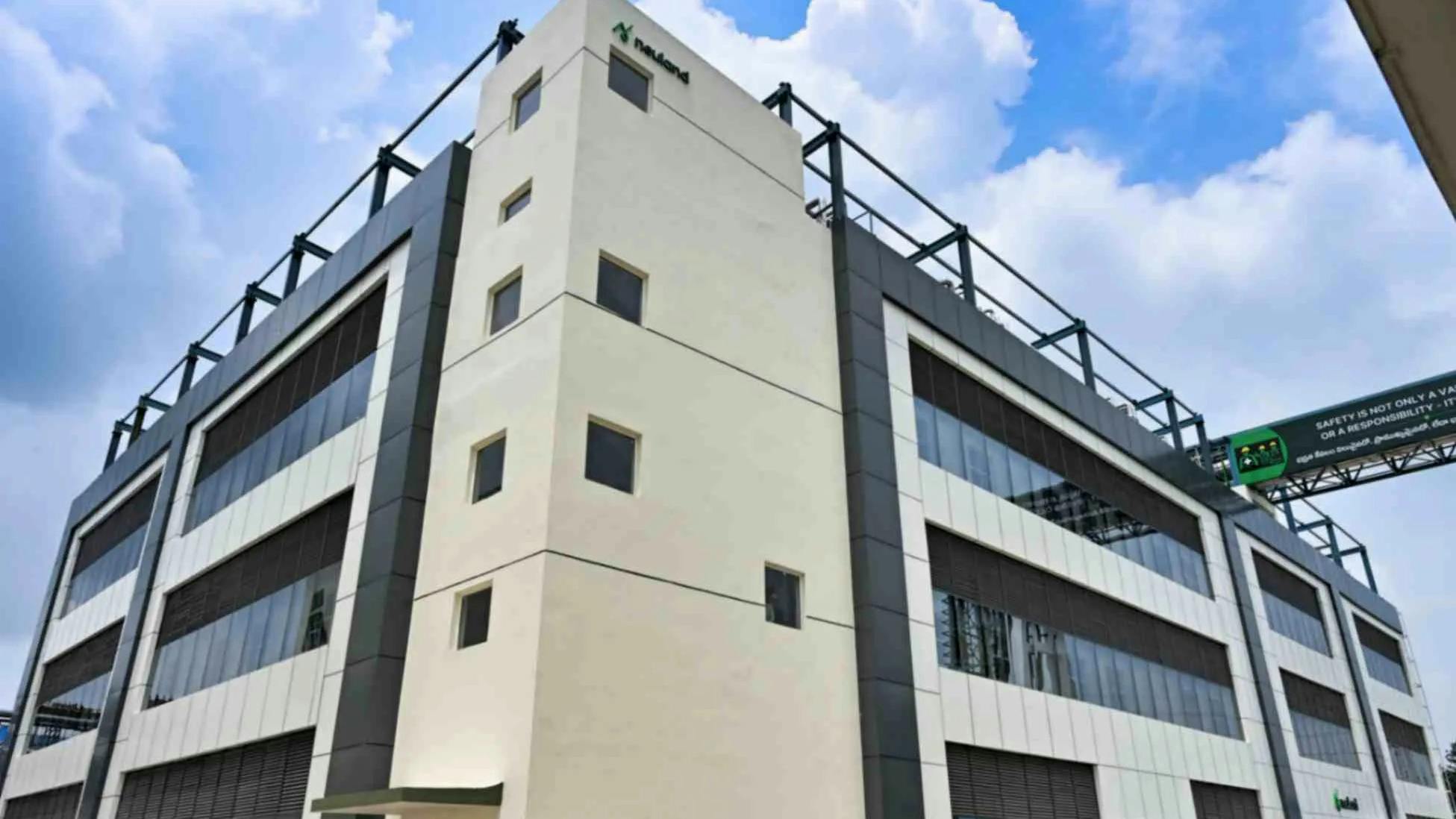 Exterior of Neuland facility with blue sky and clouds in the background