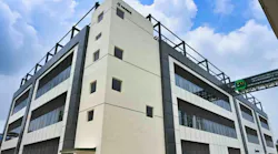Exterior of Neuland facility with blue sky and clouds in the background