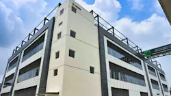 Exterior of Neuland facility with blue sky and clouds in the background