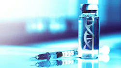 DNA strand in vial with vaccine on table.