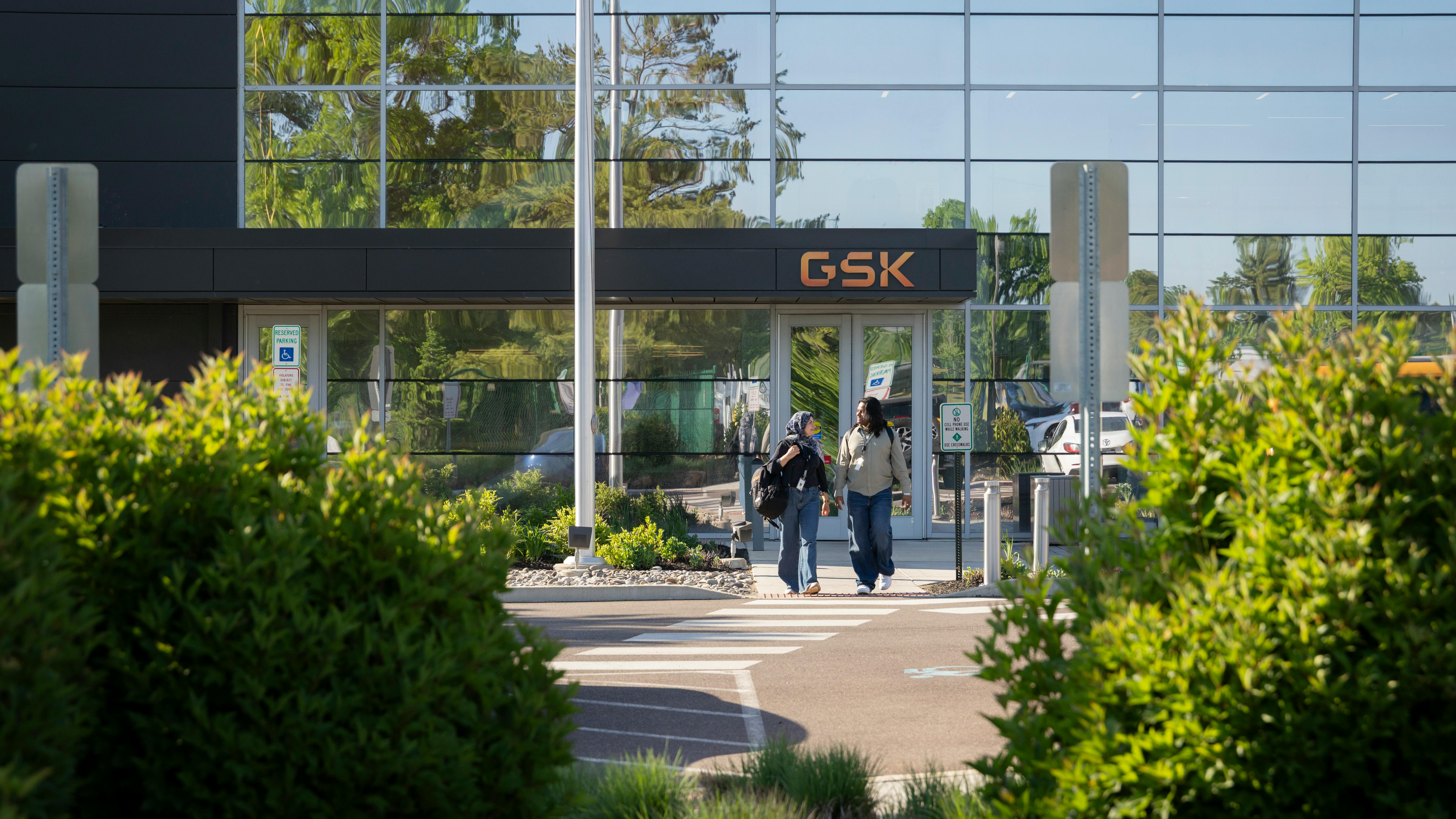 Two women walk near GSK campus in Upper Merion Township, Pennsylvania